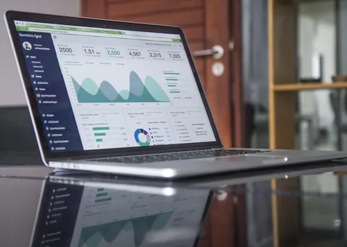 Data Visualization | CAQA Creative A laptop screen shows a data analytics dashboard relevant to film and video production.