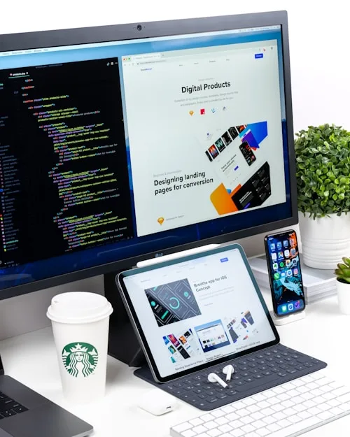 Modern Workspace | CAQA Creative A modern workspace shows a computer, tablet and smartphone, ideal for creative arts projects.